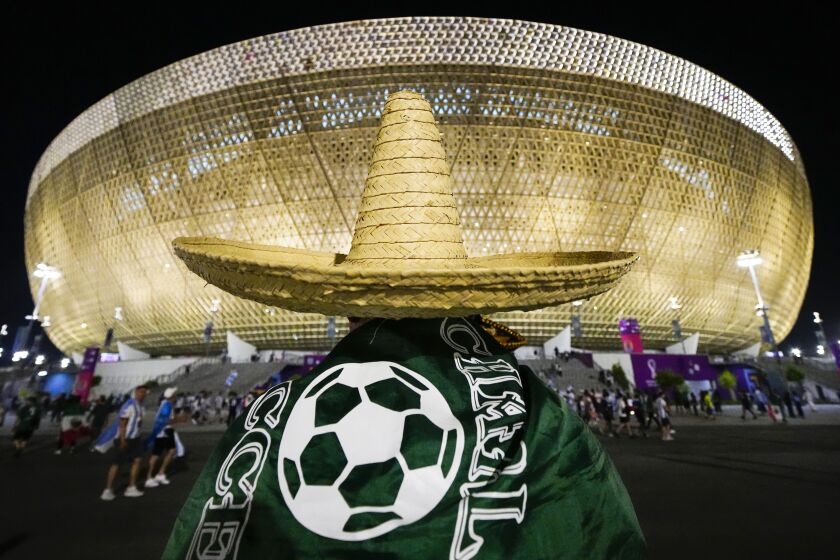 A Mexico's fan wearing a sombrero walks towards the Lusail Stadium before the World Cup group C soccer match between Argentina and Mexico at the Lusail Stadium in Lusail, Qatar, Saturday, Nov. 26, 2022. (AP Photo/Pavel Golovkin)