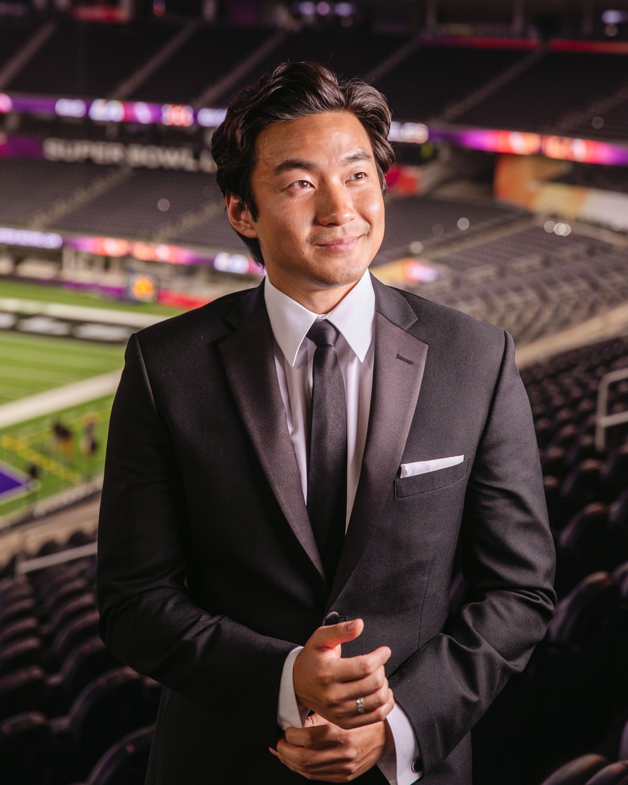 A man in a suit poses for a portrait.