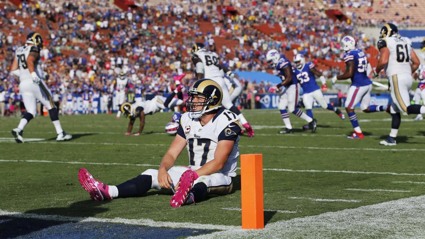 Rams quarterback Case Keenum (17) sits on the ground after being sacked by Buffalo Bills outside linebacker Lorenzo Alexander (57) on the Rams last offensive possession of the game in a 30-19 loss to the Bills.