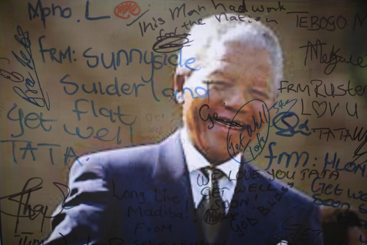 An image of former South African President Nelson Mandela on the wall of the Medi-Clinic Heart Hospital in Pretoria is covered with goodwill messages.
