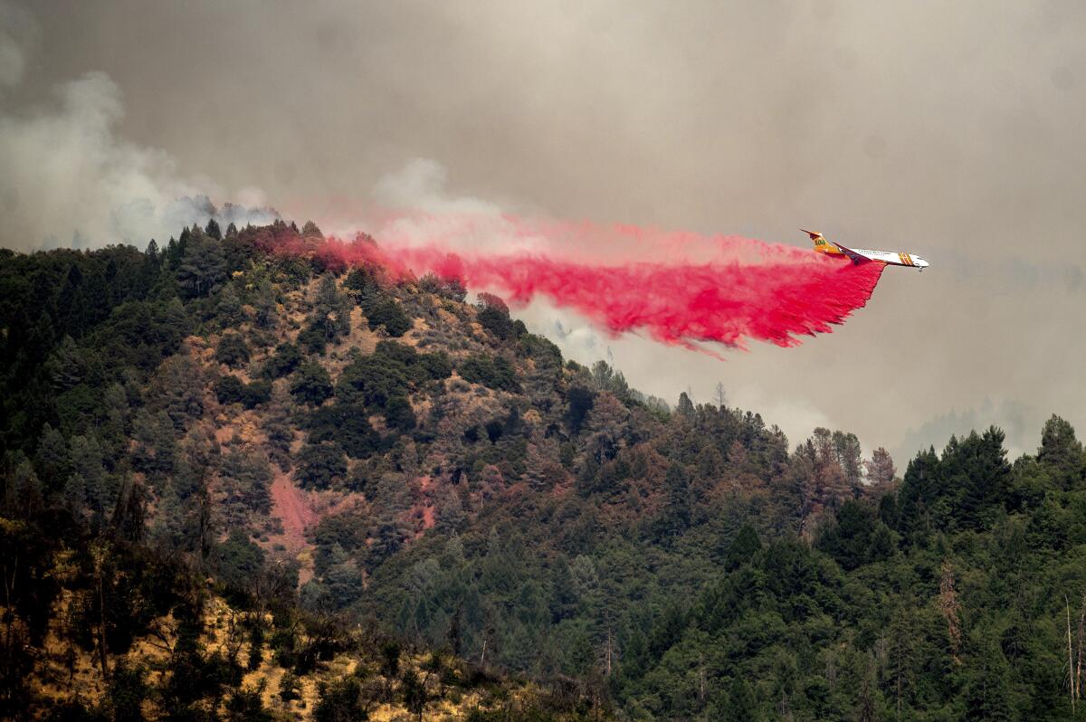 An air tanker drops retardant while trying to stop the Salt Fire from spreading near Lakehead in unincorporated Shasta County, Calif., on Friday, July 2, 2021. (AP Photo/Noah Berger)