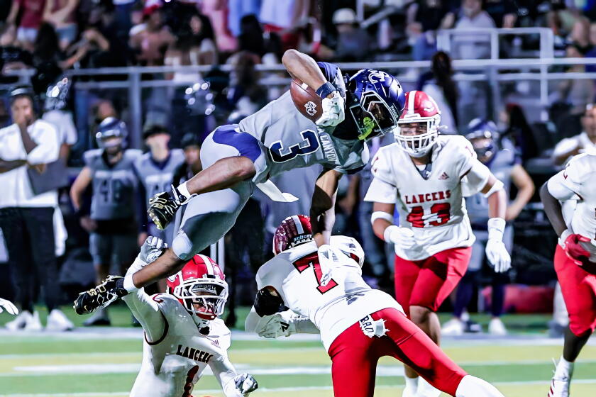 Jaxsen Stokes of Sierra Canyon goes for the hurdle against Orange Lutheran.