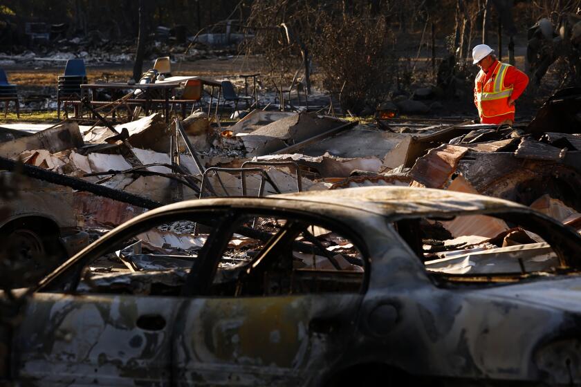Genaro Molina  Los Angeles Times A PG&E FOREMAN surveys damage in Santa Rosa, Calif., in October 2017 after the Tubbs fire, which at the time was the most destructive in California history.