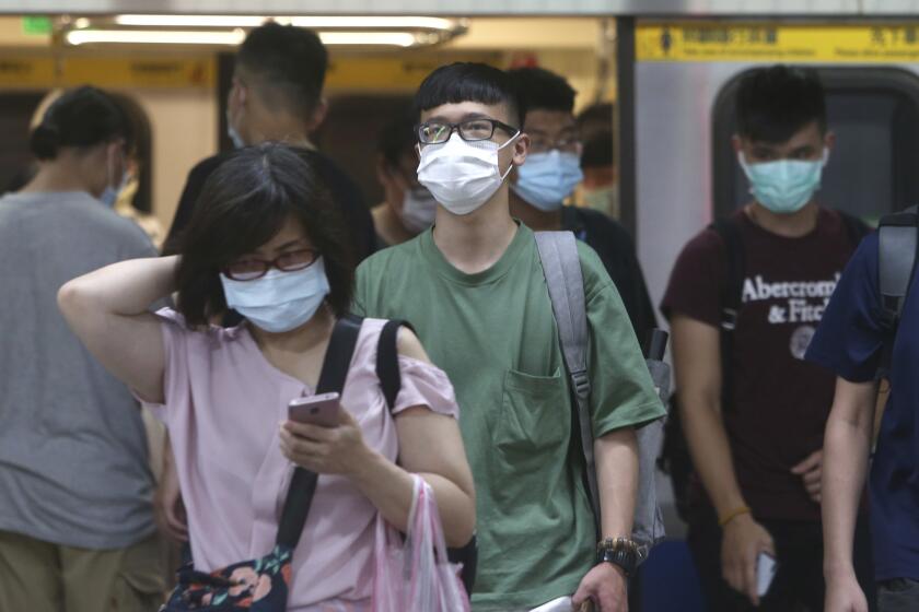 People wear face masks to protect against the spread of the coronavirus as they ride the subway in Taipei, Taiwan, Saturday, June 13, 2020. (AP Photo/Chiang Ying-ying)
