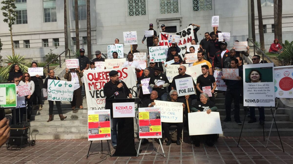 Dozens of residents speak out against the Reef redevelopment project at a news conference Tuesday outside City Hall.