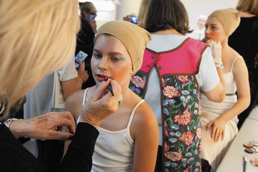 Make-up artist Dee Ketner works on Greta Harmon backstage during the 2015 Pageant of the Masters Press Night on Tuesday.