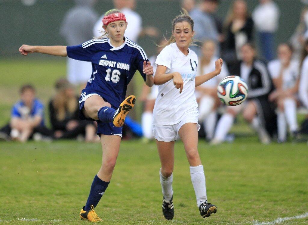 Newport Harbor High's Grace Blackman (16) competes against Corona del Mar's Nicole Lloyd during the second half in the Battle of the Bay match on Tuesday.