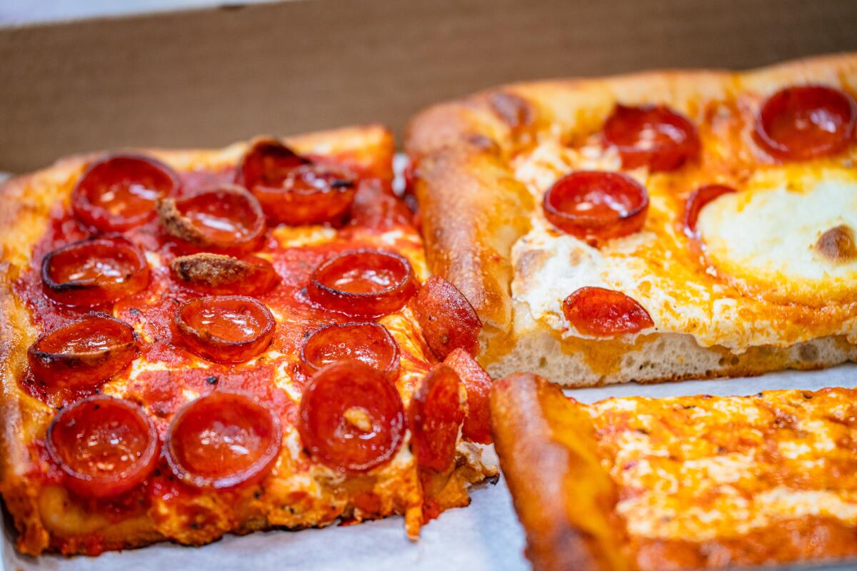 Prince St. Pizza offers multiple pizza styles, like Sicilian-style squares with a fluffy crust.