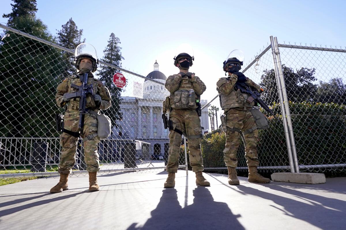 Three California National Guard members stand guard