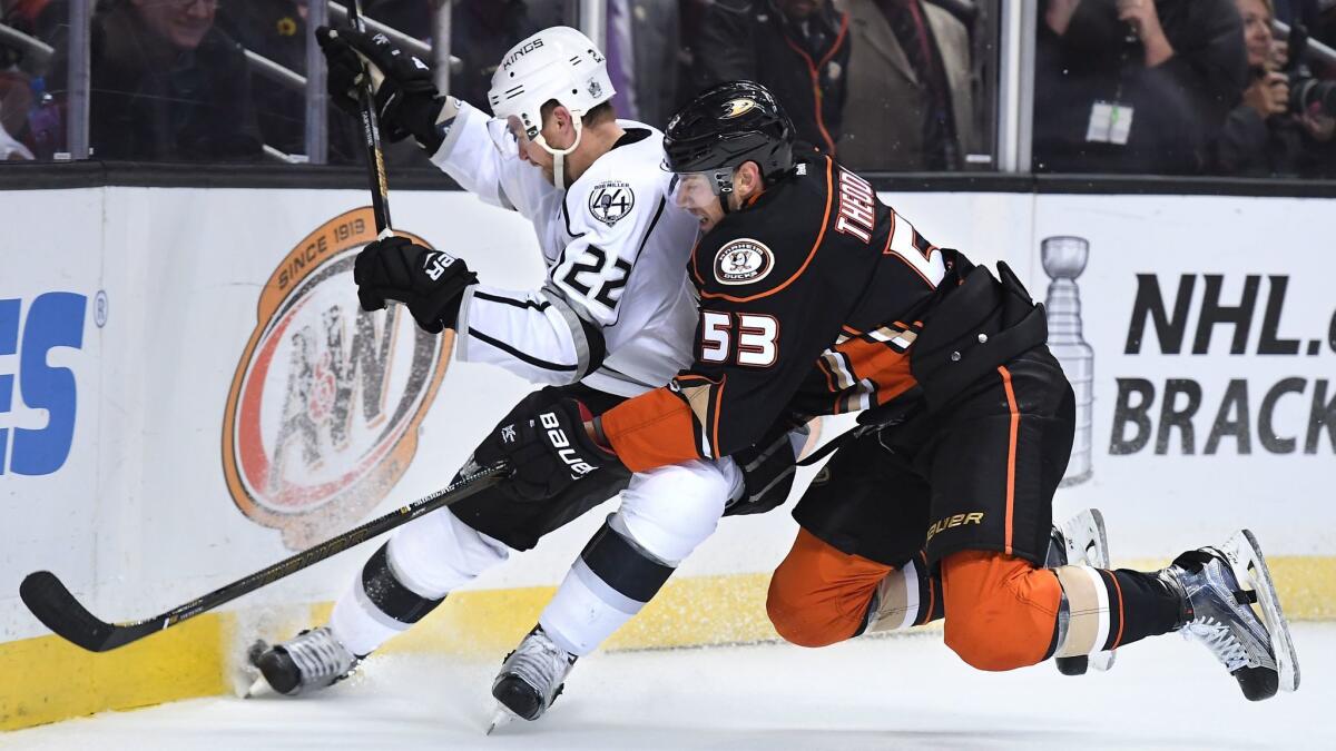The Kings Trevor Lewis and the Ducks' Shea Theodore battle for the puck on April 9.