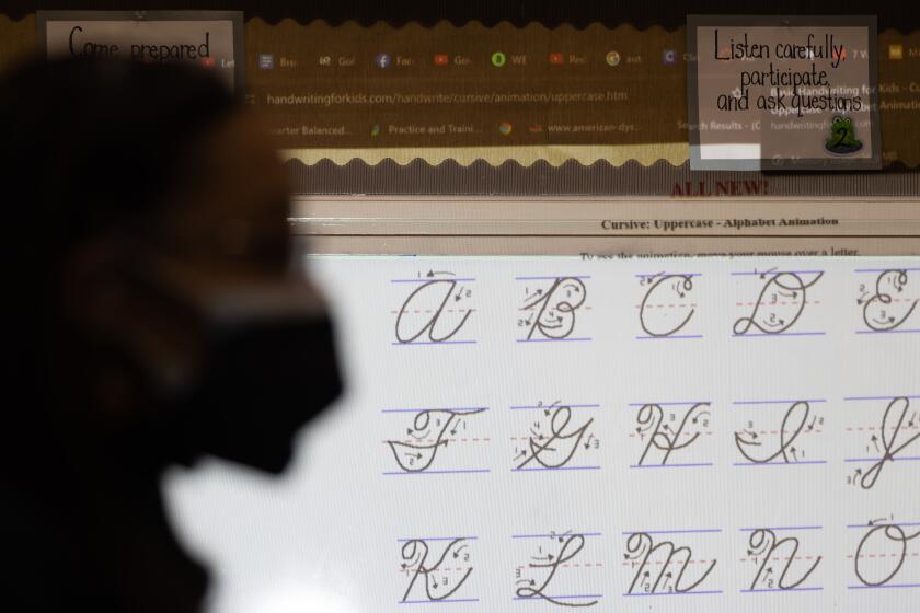 PASADENA-CA-DECEMBER 14, 2023: Tyara Brooks teaches her fourth grade students how to write in cursive at Longfellow Elementary School in Pasadena on December 14, 2023. (Christina House / Los Angeles Times)