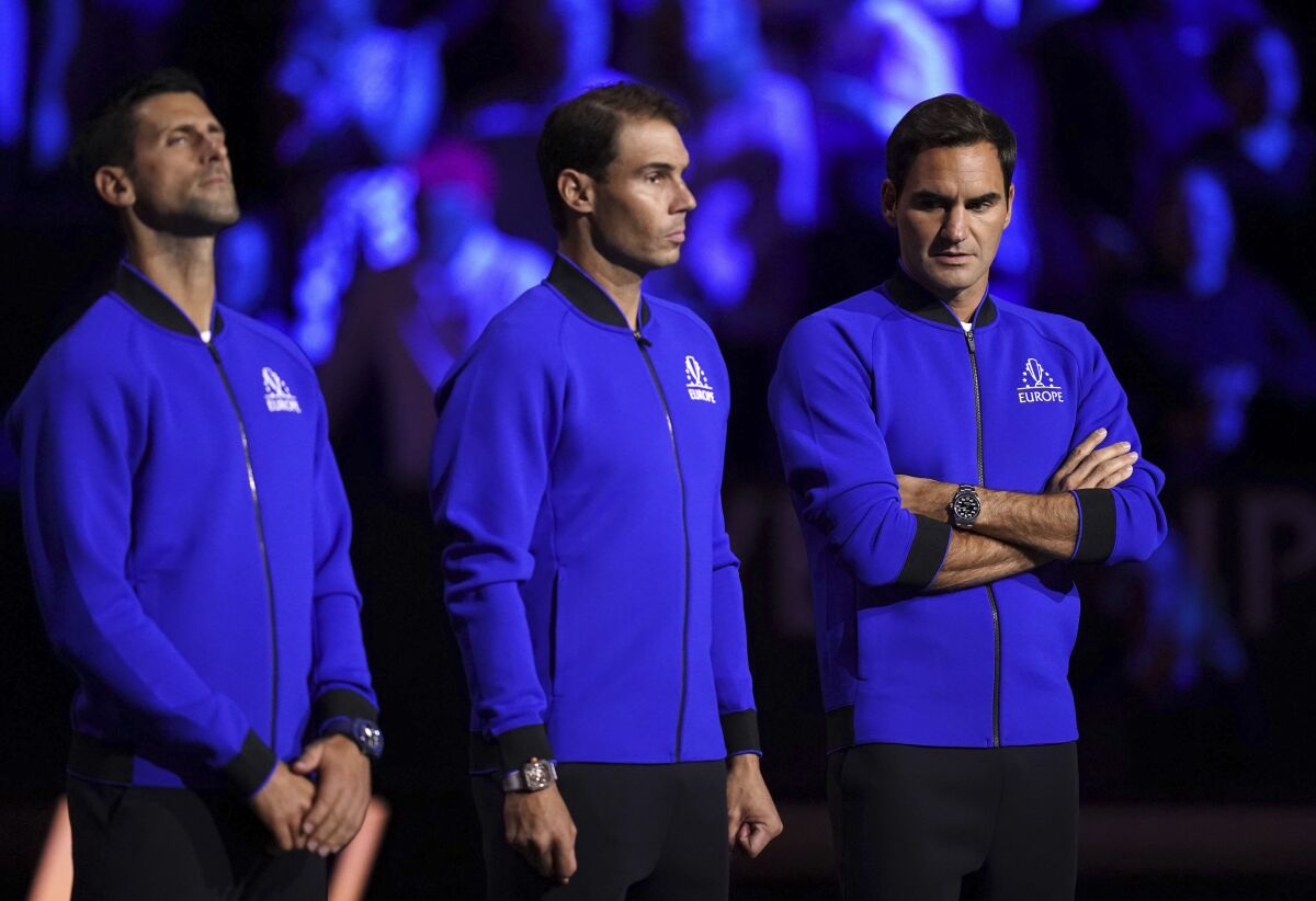 Team Europe's Novak Djokovic, Rafael Nadal and Roger Federer line up on the court ahead of day one of the Laver Cup at the O2 Arena in London, Friday Sept. 23, 2022. (John Walton/PA via AP)