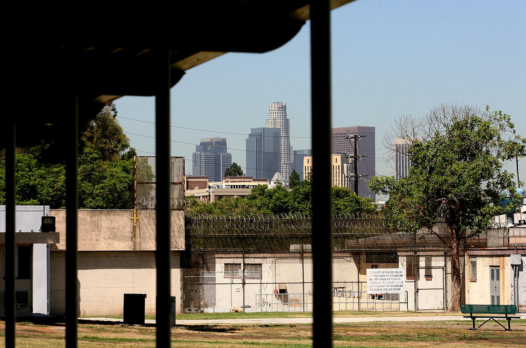 A view of the downtown L.A. skyline framed by an awning at a detention center