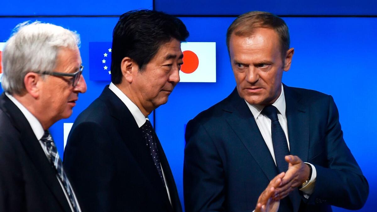 European Council President Donald Tusk, from right, Japanese Prime Minister Shinzo Abe and European Commission President Jean-Claude Juncker speak July 6 at a news conference.