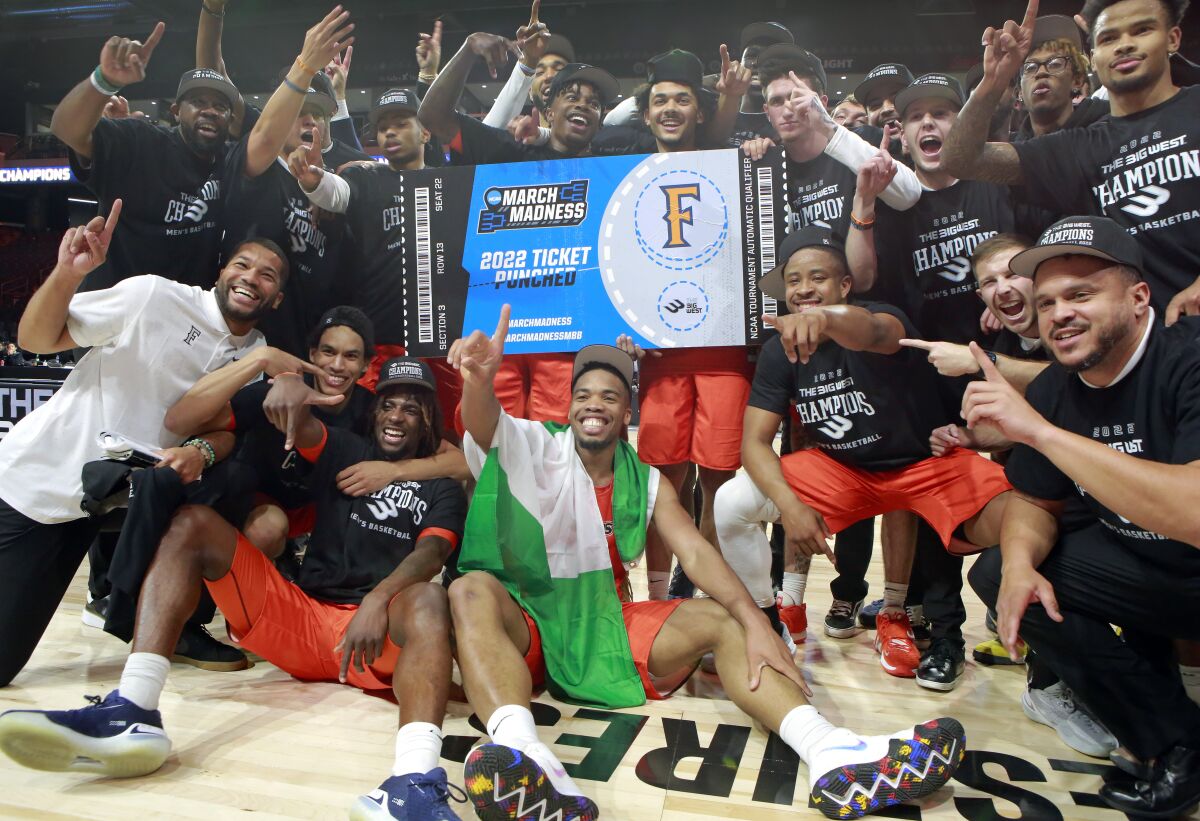 Cal State Fullerton celebrates an NCAA college basketball game against Long Beach State.