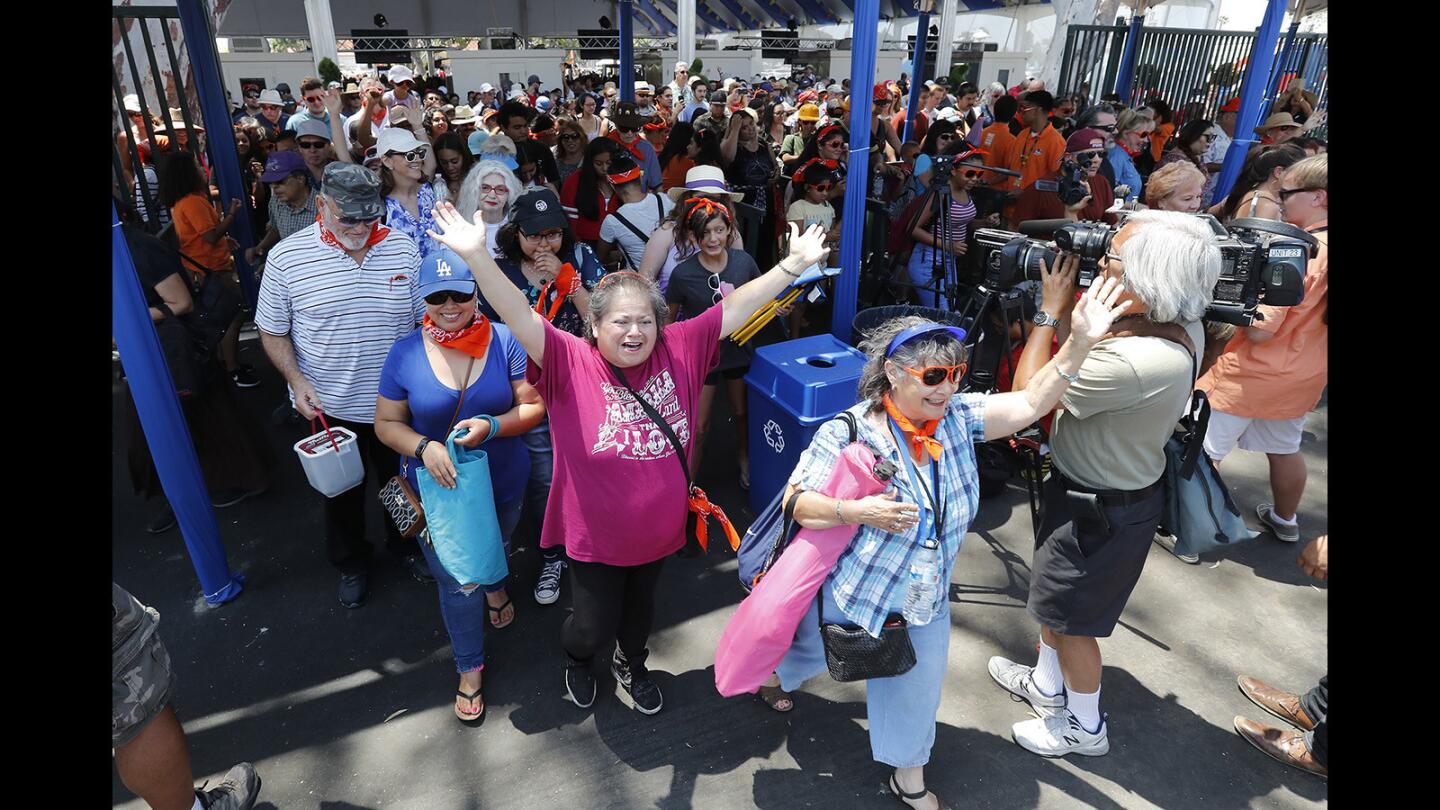Hundreds of visitors file through the Blue Gate during opening day for the Orange County Fair in Costa Mesa on Friday, July 13.