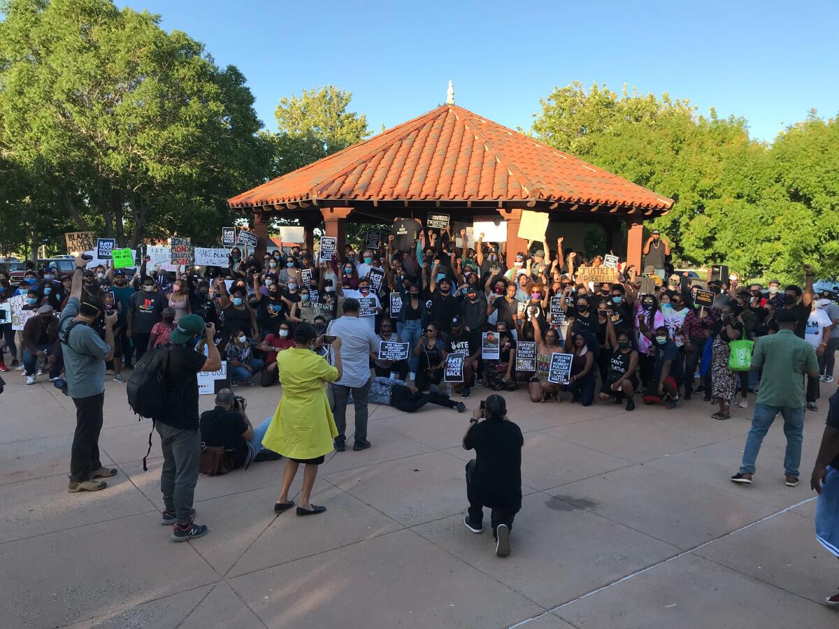 Demonstrators pose for a photo at Poncitlan Square in Palmdale