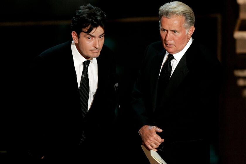 Charlie Sheen, left, and his father, Martin Sheen, present during the 58th Primetime Emmy Awards in August 2006. The younger Sheen announced this week that he is HIV-positive.