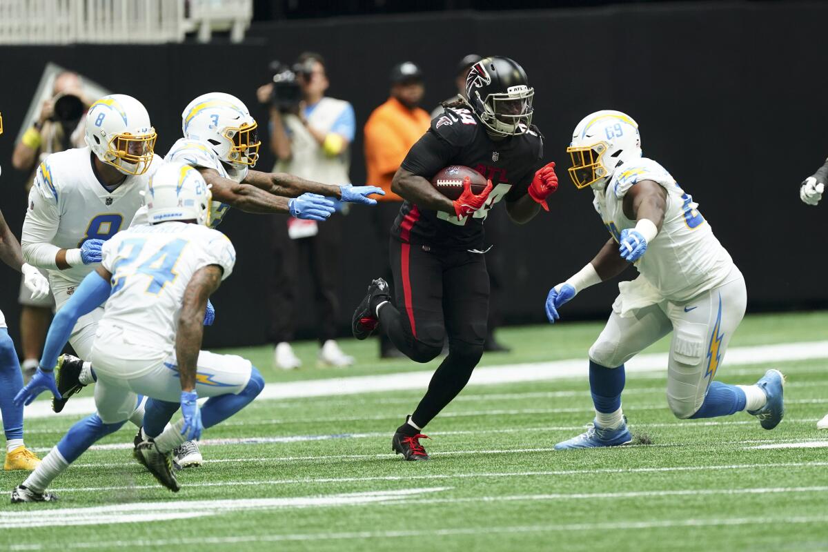 Chargers defensive tackle Sebastian Joseph-Day, right, pursues  Falcons running back Cordarrelle Patterson (84).