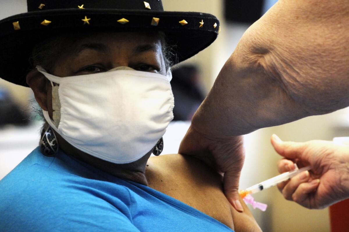 Georgette Moon receives a COVID-19 vaccine at the county health department in Tuskegee, Ala.,on Jan. 25.