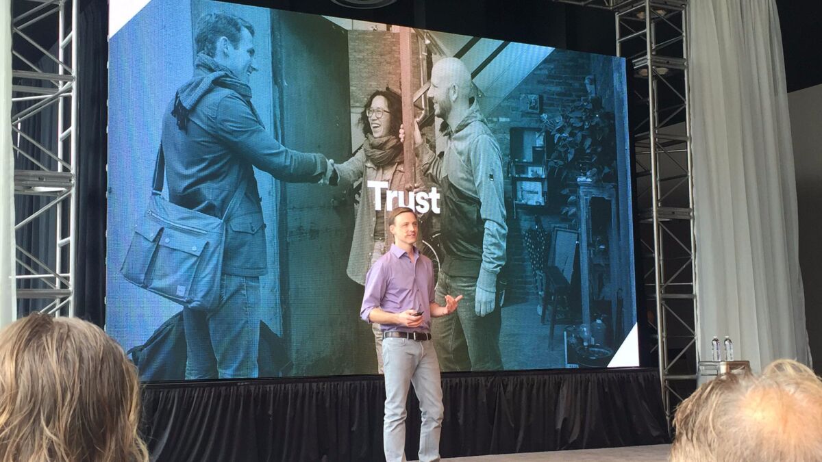 Airbnb's vice president of engineering, Mike Curtis, addresses the audience at the company's annual OpenAir conference.