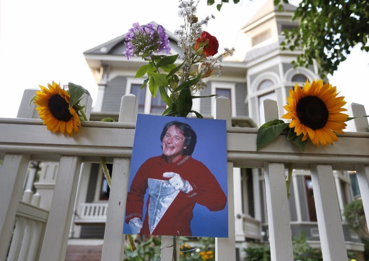 A photo of the late actor Robin Williams as Mork from Ork hangs outside the home in Boulder, Colo., where "Mork & Mindy" was set.