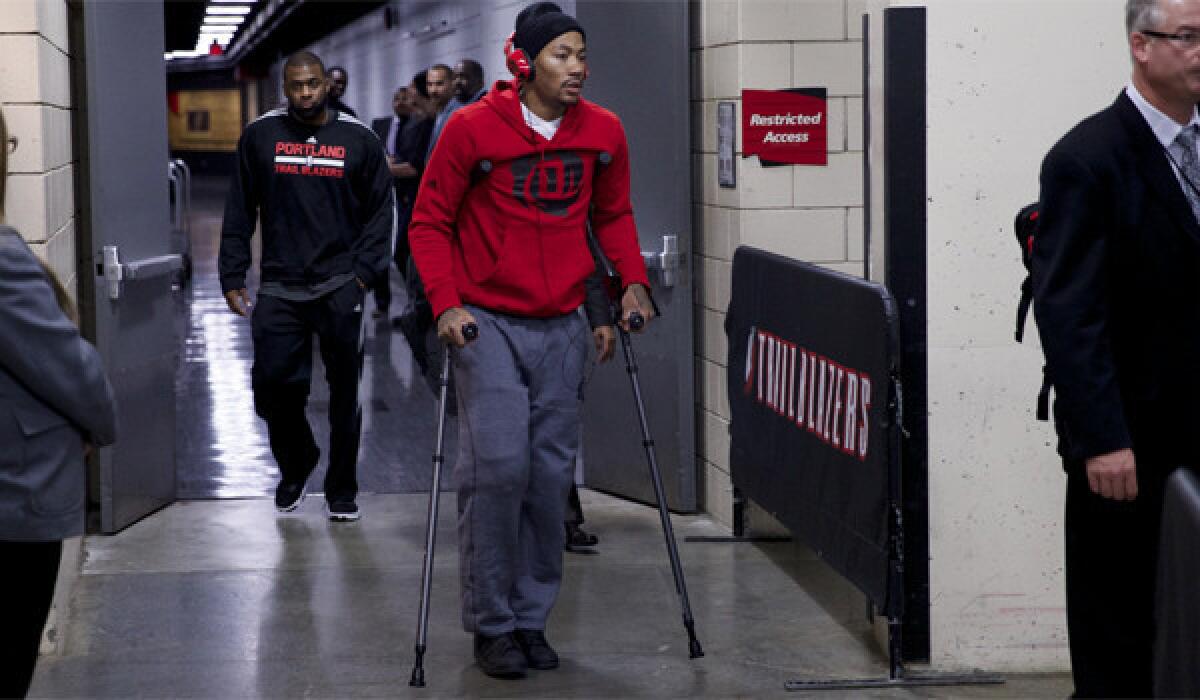 Chicago point guard Derrick Rose leaves the Moda Center on crutches Friday after he was injured during a game against the Portland Trail Blazers.