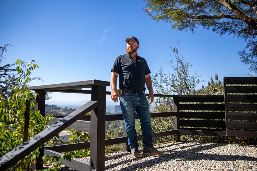 LOOS ANGELES, CA - AUGUST 30: Structural assessor, Kyle Tourje, assesses a property where unpermitted decks, raised fruit and plant beds are tucked into a hillside on Tuesday, Aug. 30, 2022 in Loos Angeles, CA. (Jason Armond / Los Angeles Times)