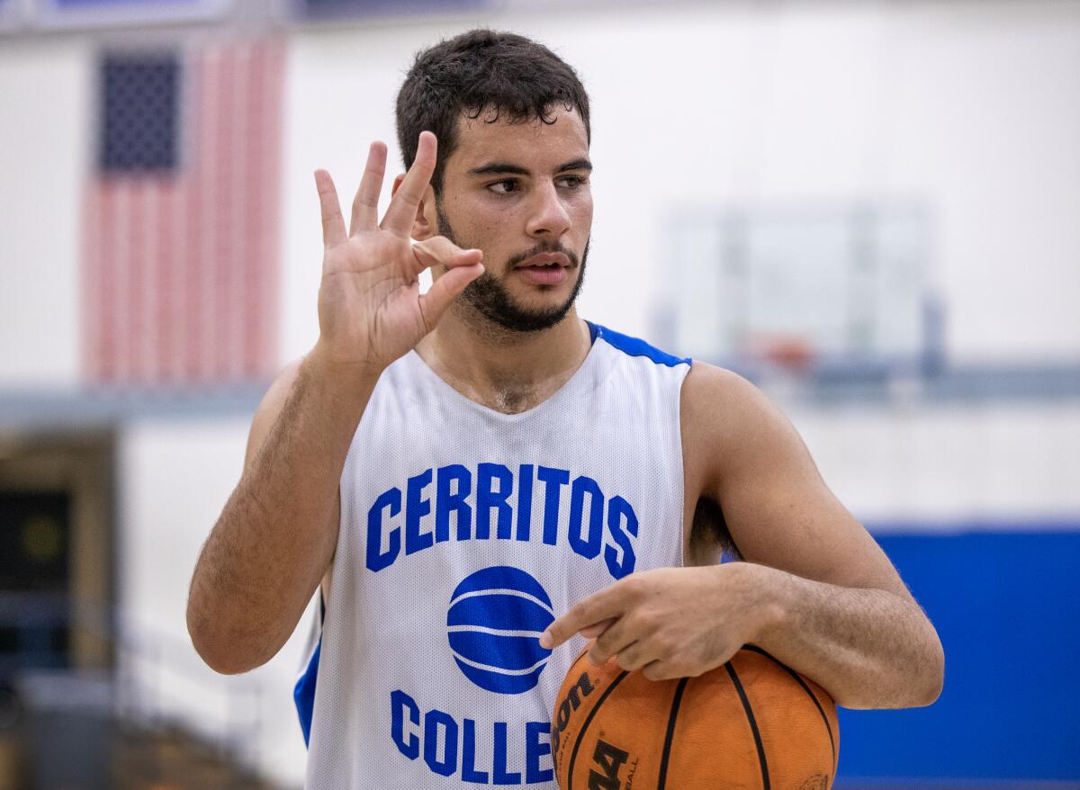 Kade West uses sign language to communicate while practicing with Cerritos College.