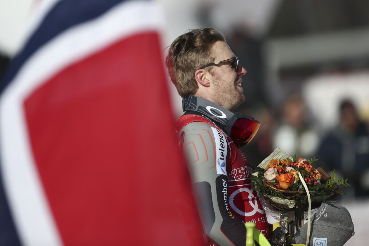 Norway's Aleksander Aamodt Kilde, winner of an alpine ski, men's World Cup super-G, listens to the national anthem on the podium, in Kvitfjell, Norway, Sunday March 6, 2022. (AP Photo/Gabriele Facciotti)