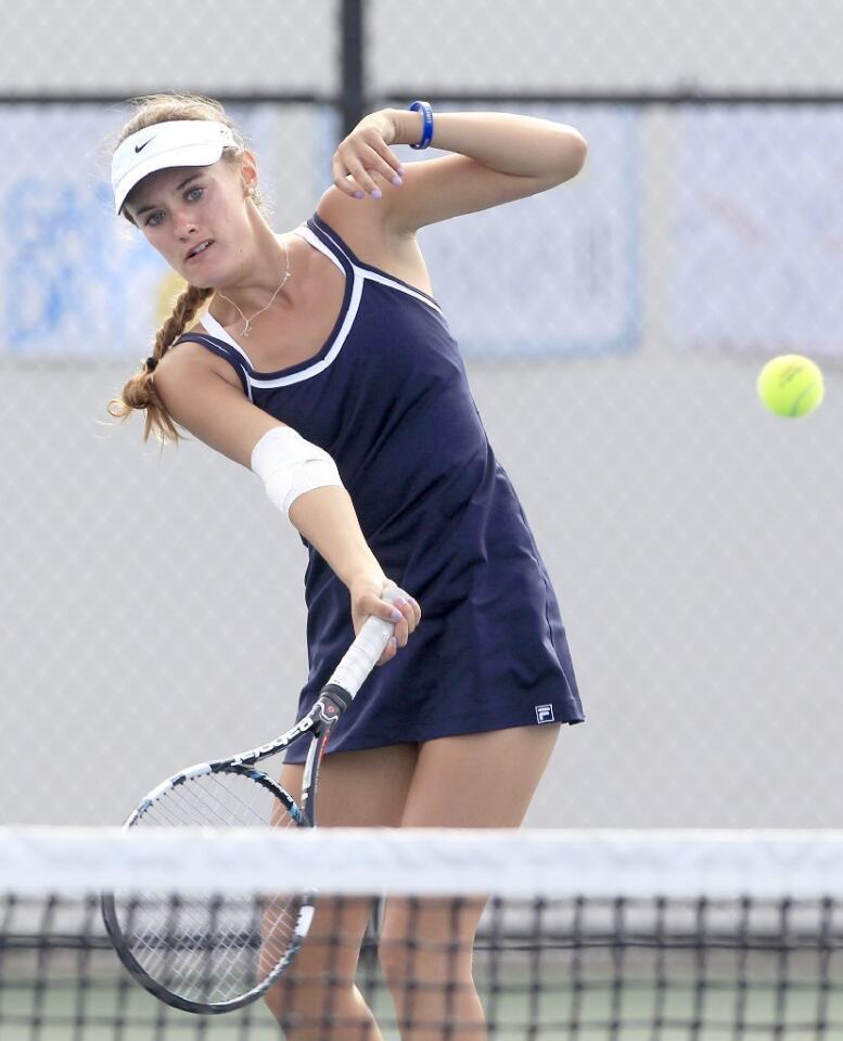 Newport Harbor High's Kendall Cosenza competes in a doubles set against Corona del Mar during the Battle of the Bay match on Tuesday.