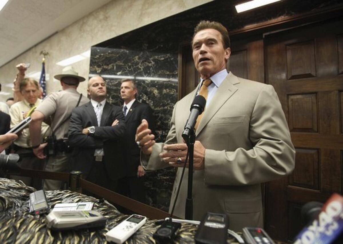 Gov. Arnold Schwarzenegger talks with reporters about his negotiations with legislative Democrats aimed at closing the budget gap.
