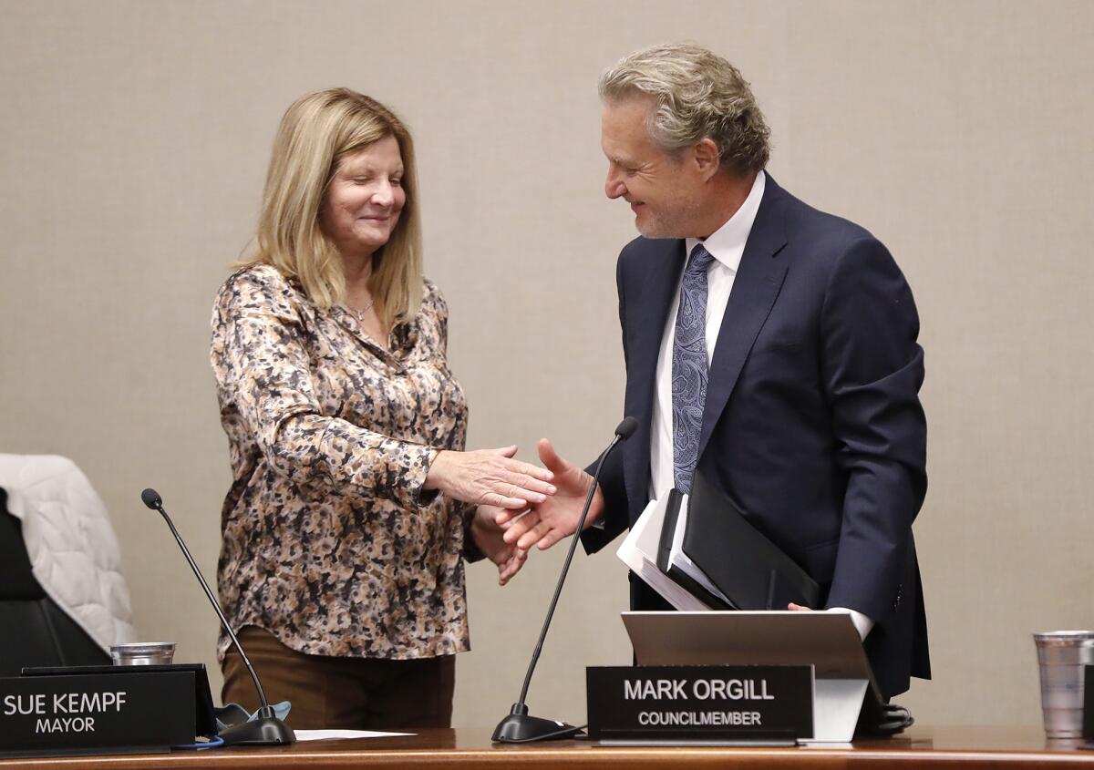 Mayor pro tem Sue Kempf congratulates newly sworn-in Councilman Mark Orgill on Tuesday.