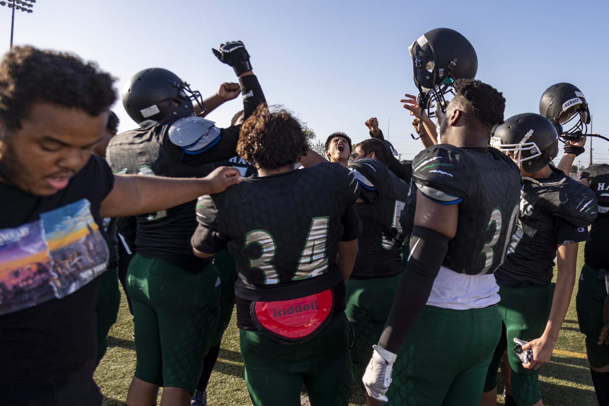 Hawkins High football players give a cheer following a 27-0 loss to Manual Arts.