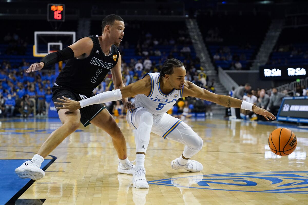 UCLA's Amari Bailey reaches for the ball.