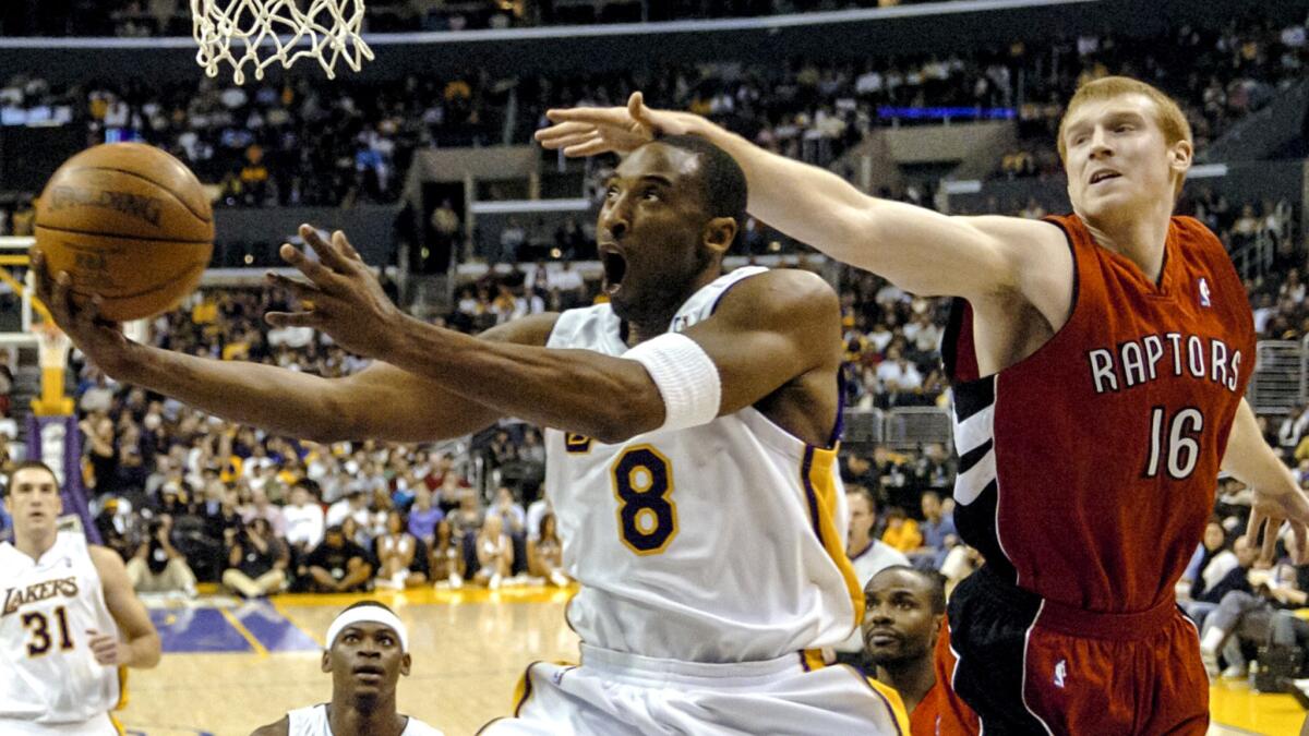 In this Jan. 22, 2006, file photo, Toronto Raptors' Matt Bonner can't stop Los Angeles Lakers' Kobe Bryant from getting to the basket in the first half of NBA basketball game in Los Angeles.