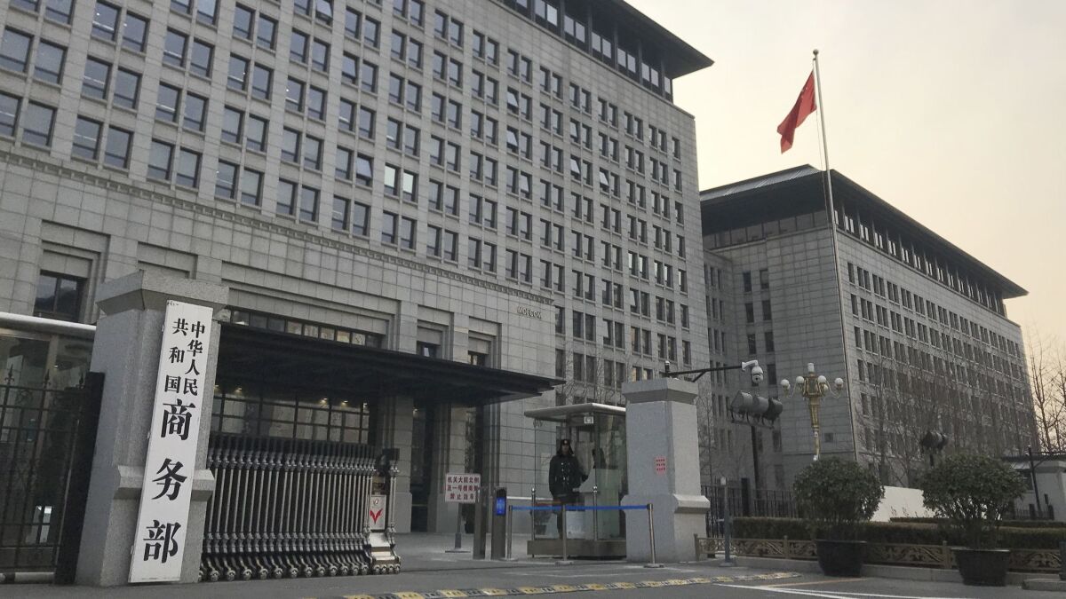 A Chinese guard stands at the entrance of the Ministry of Commerce in Beijing on Wednesday, where U.S. and Chinese envoys extended trade talks into a third and final day.