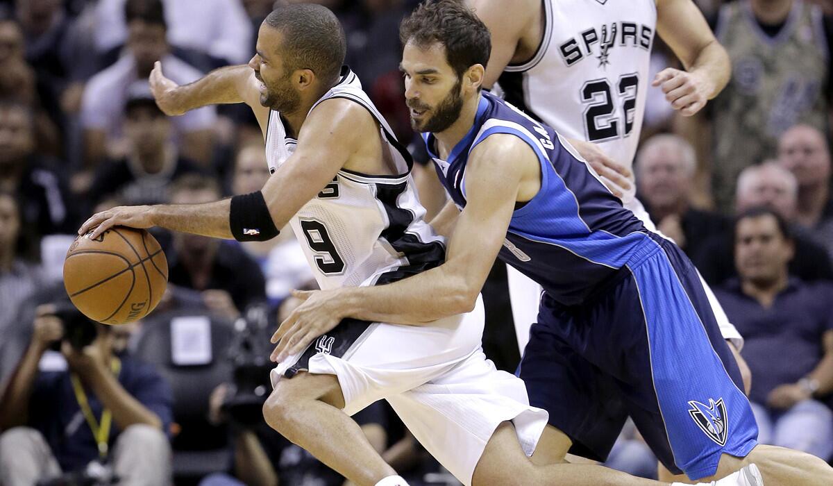 Spurs point guardTony Parker (9 is fouled by Mavericks point guard Jose Calderon on a drive in the second half Wednesday night in San Antonio.