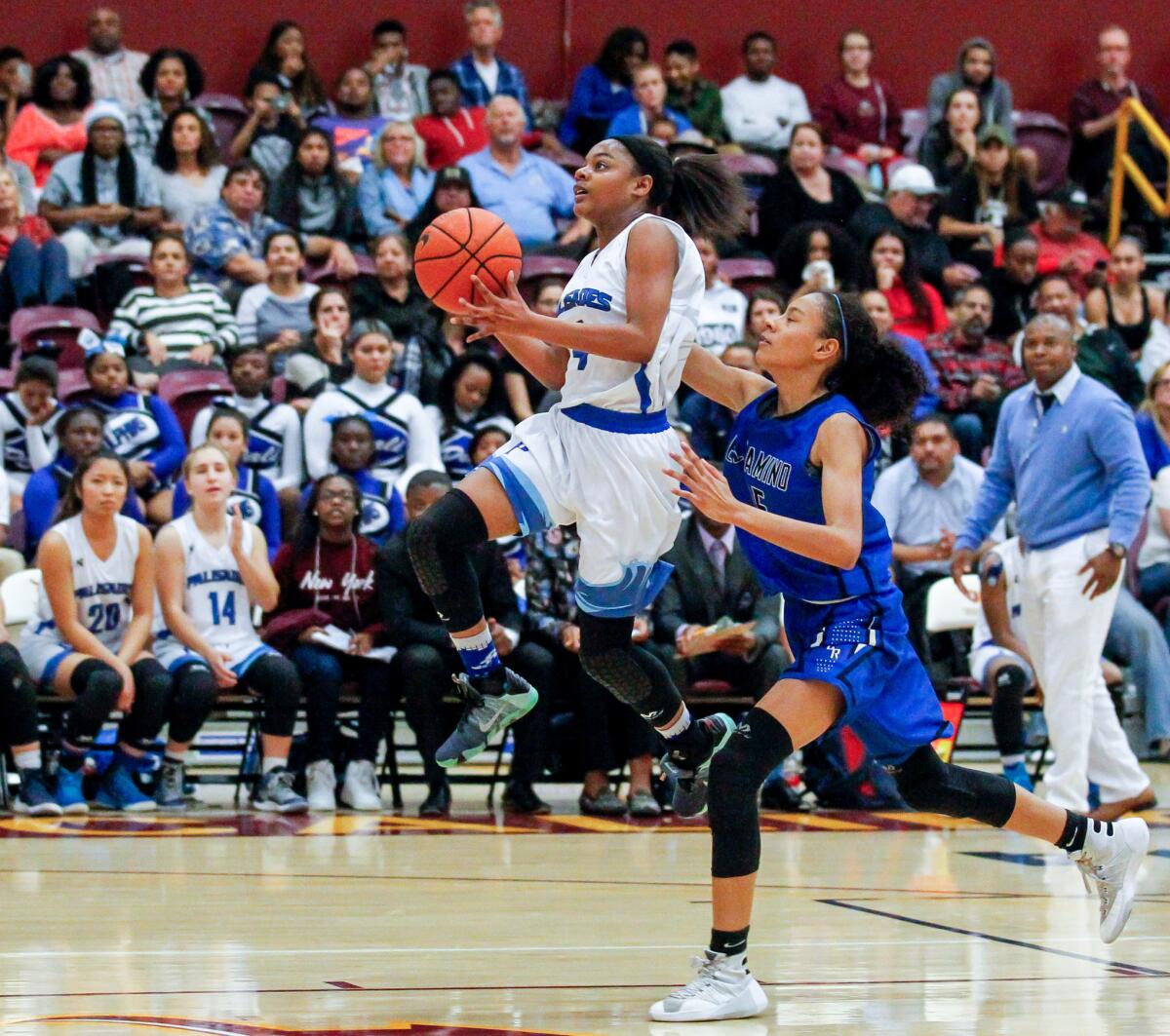 Palisades' Kayla Williams (left) gets airborne for a layup against El Camino Real during the City Section Open Division girls basketball final on March 5.
