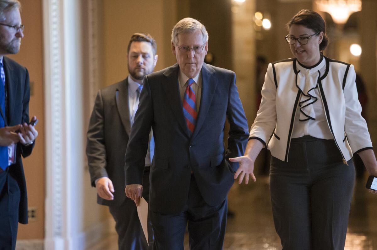 Senate Majority Leader Mitch McConnell walks to the Senate chamber on Capitol Hill on Wednesday as the Senate worked on a rescue package for debt-stricken Puerto Rico.