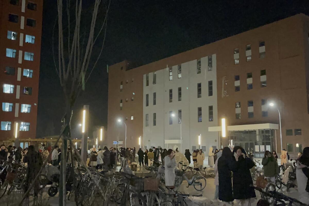 Students stand outside an evacuated dorm.