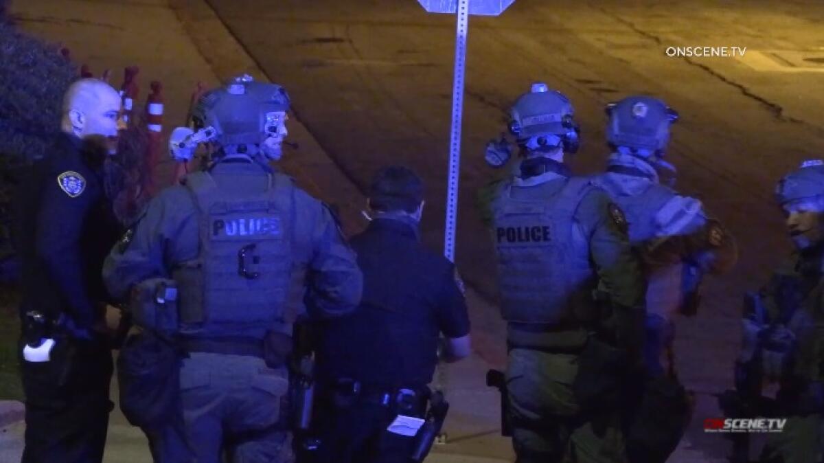 SWAT officers gather on a street corner