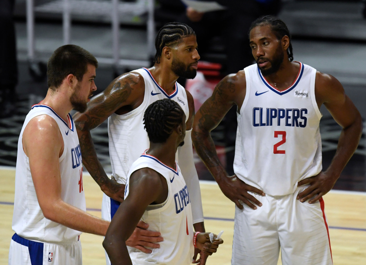 Kawhi Leonard (2), Paul George (13) Ivica Zubac (40) and Reggie Jackson talk before a preseason game against the Utah Jazz.