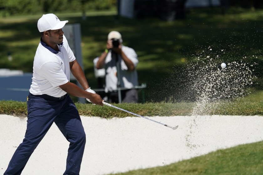 Harold Varner III hits out of a bunker on the eighth green.