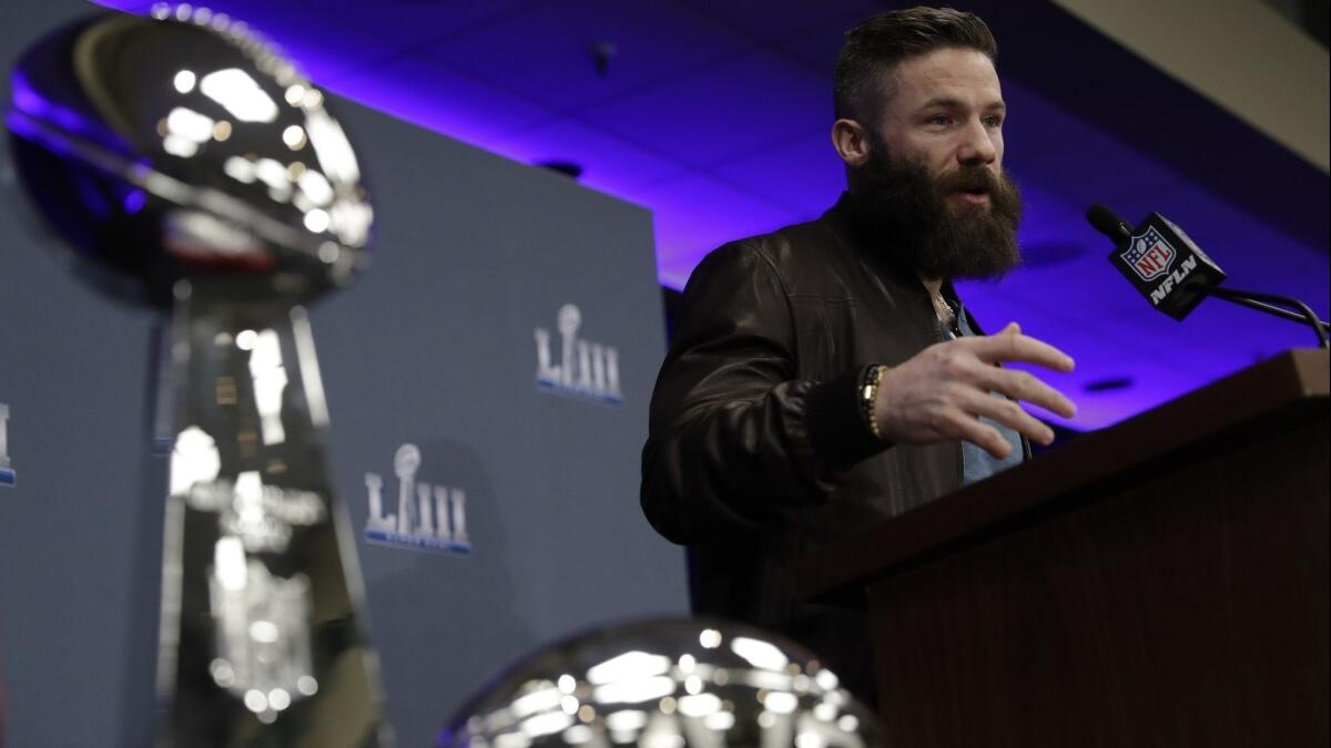 New England receiver Julian Edelman answers questions near the Lombardi Trophy and his Super Bowl MVP trophy during a news conference Feb. 4 in Atlanta.