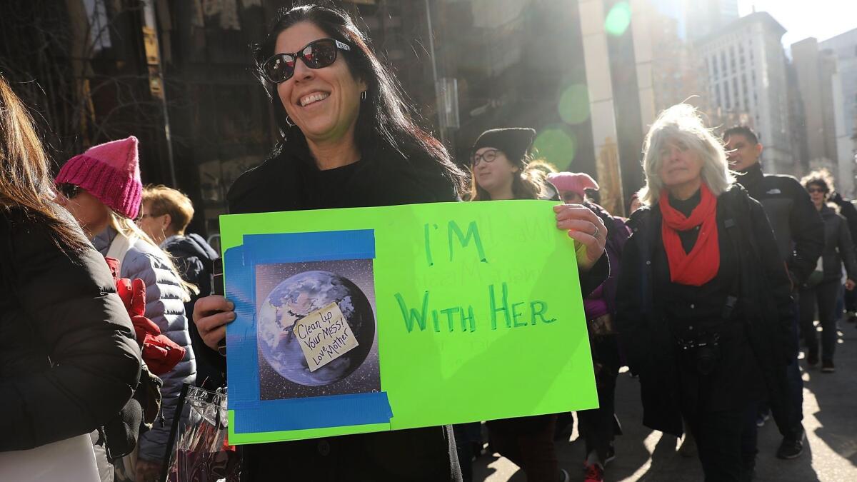 A marcher in New York was one of many with signs with environmental themes.