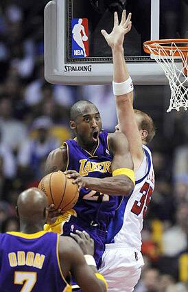 Lakers Kobe Bryant drives to the basket against Clippers Chris Kaman in the first quarter Wednesday night.