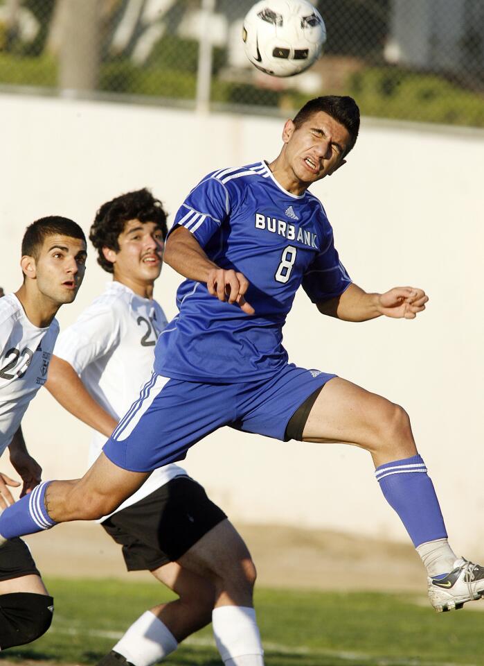 Burbank's Tadeh Anbarchian, on a direct kick, attempts to get a head on the ball for a shot attempt against Hoover in the second half in a Pacific League boys soccer game at Hoover High School on Friday, February 3, 2012. Burbank won the game 2-1.
