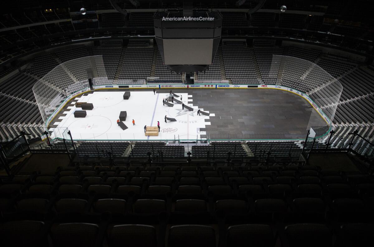 Crews cover the ice at American Airlines Center in Dallas after the NHL season was put on hold on March 12 because of the coronavirus.