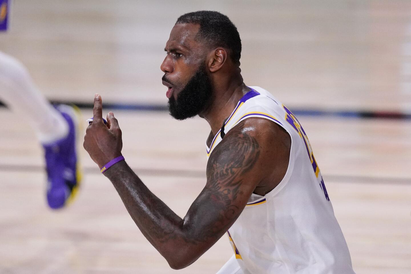 The Lakers' LeBron James celebrates during the second half Saturday against the Rockets.